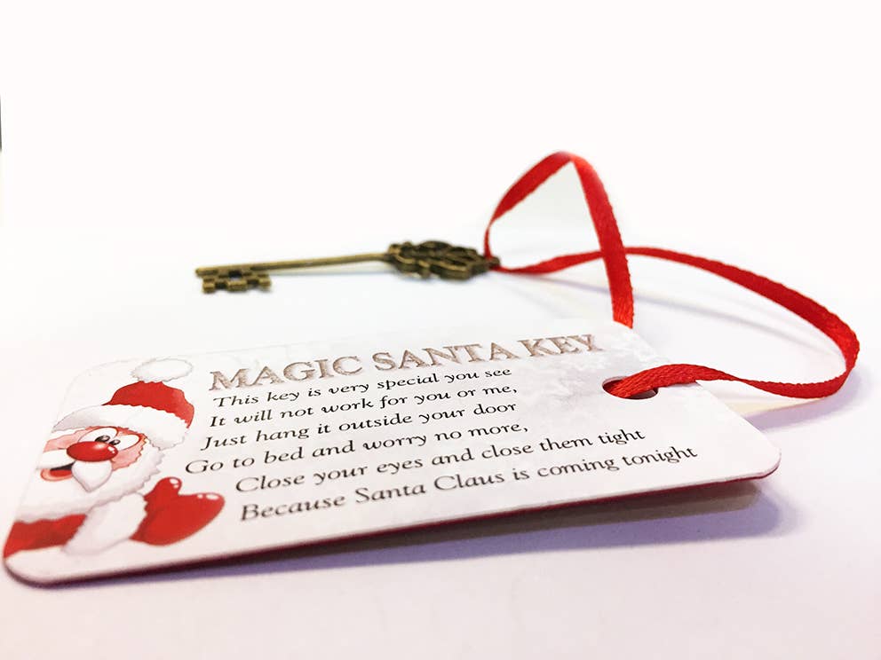 Decorative key with a tag featuring Santa Claus and text on a white background