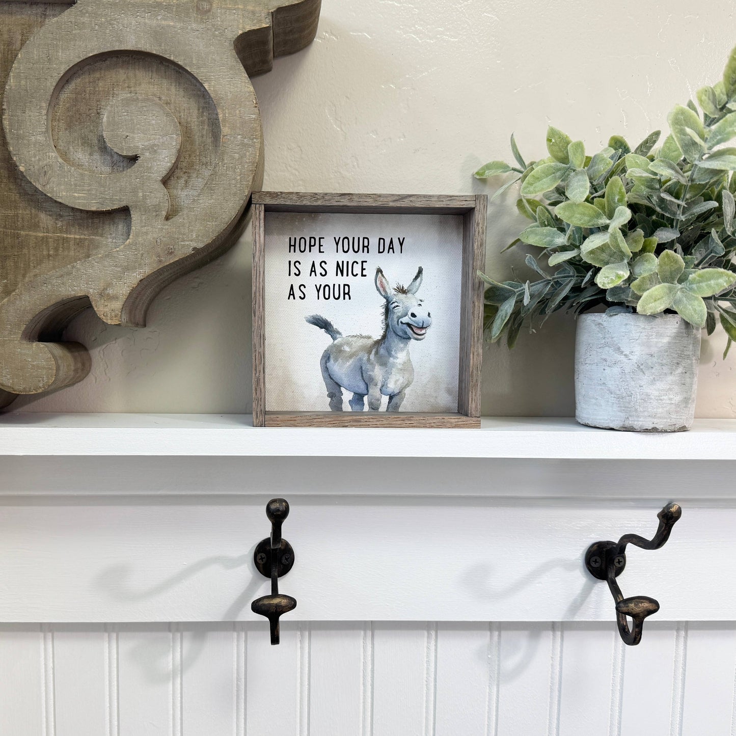 Framed picture with a donkey illustration and text on a neutral background