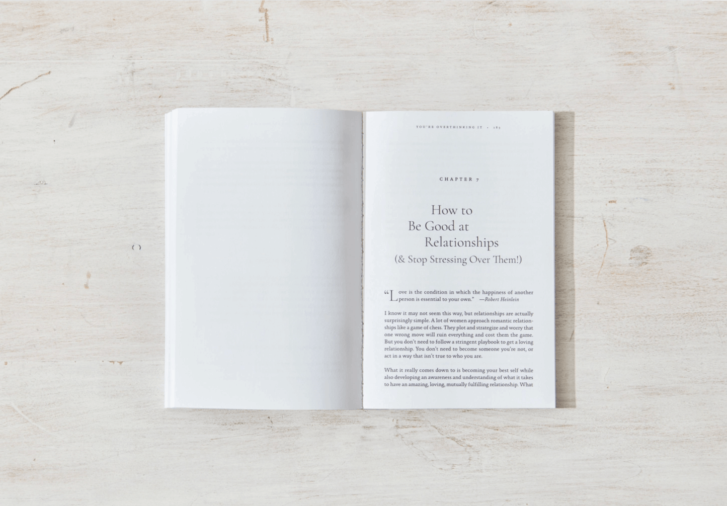 Open book on a light wooden surface with text visible