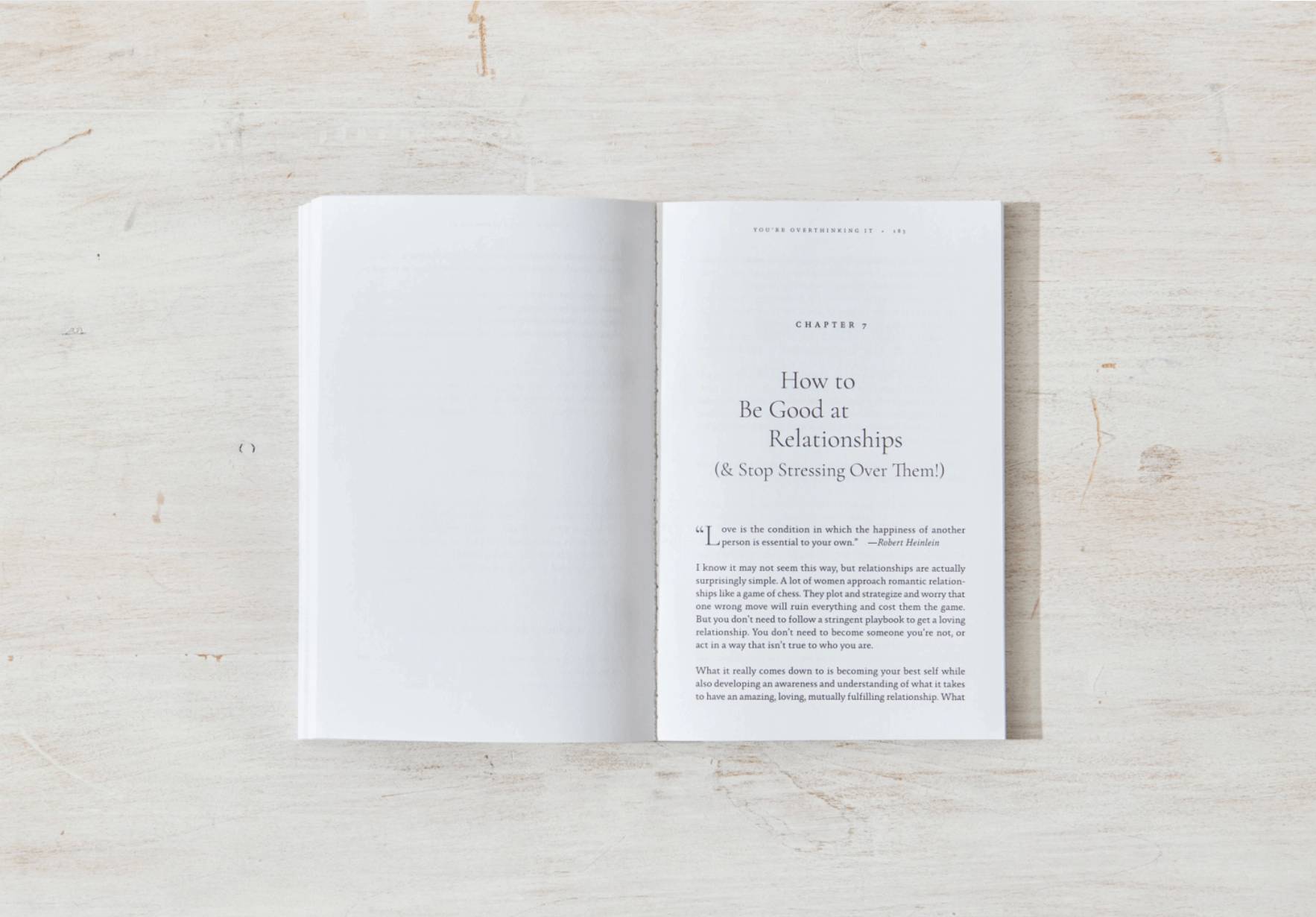 Open book on a light wooden surface with text visible