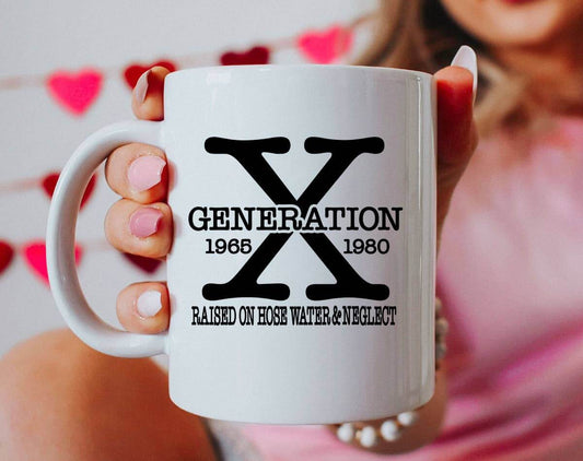 White mug with 'Generation X' design held by a person against a blurred background
