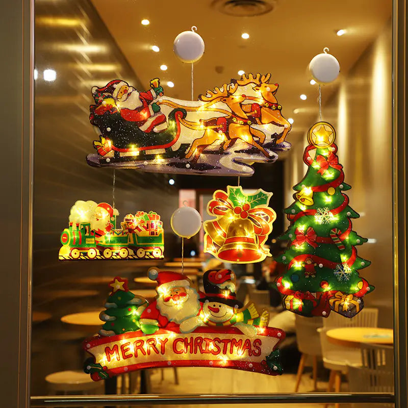 Decorative Christmas window display with lights and festive elements.