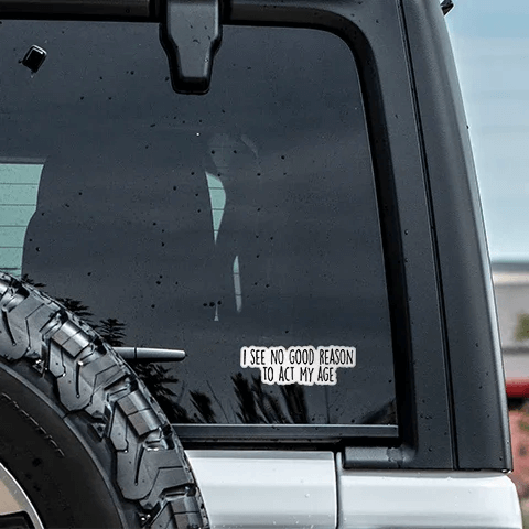 Car window with a decal and tire visible