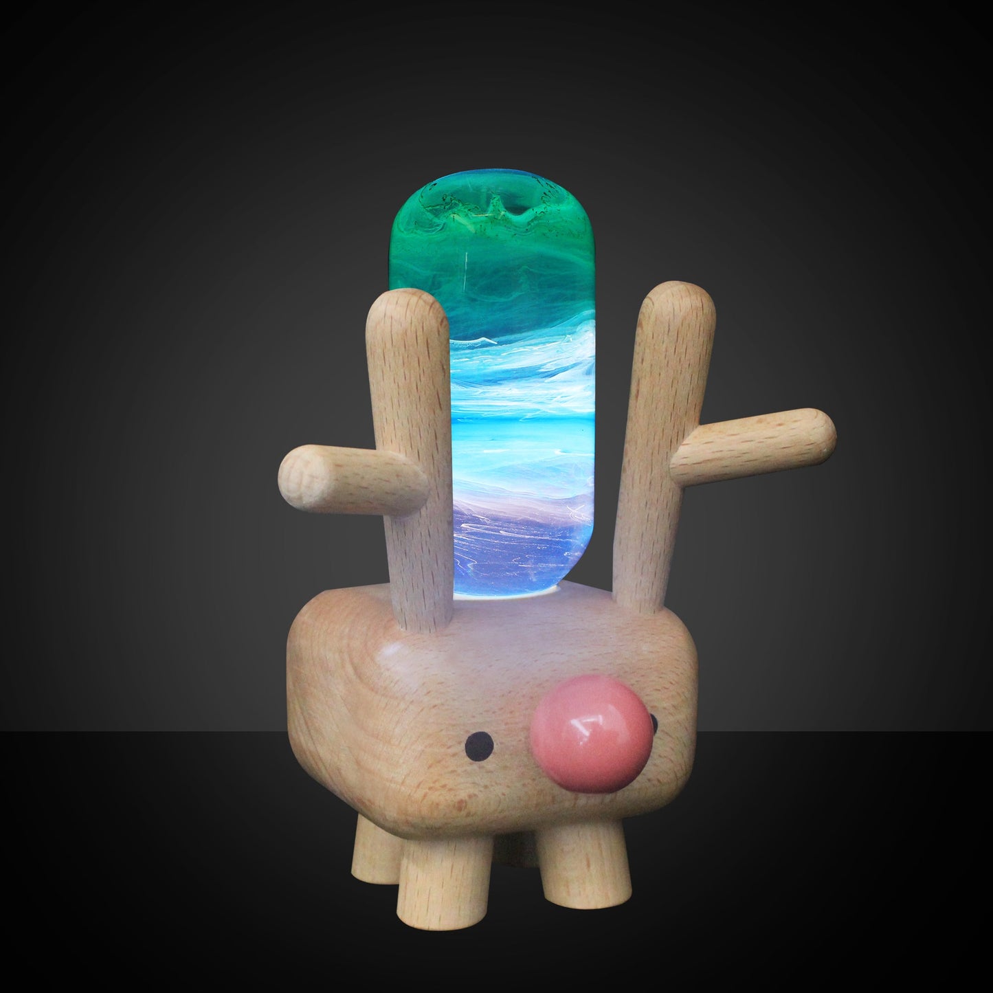 Wooden rabbit figure with a colorful stone on its back against a dark background