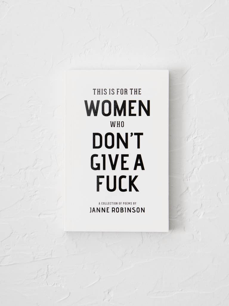 Book titled 'This is for the Women Who Don't Give a Fuck' by Janne Robinson on a textured white background