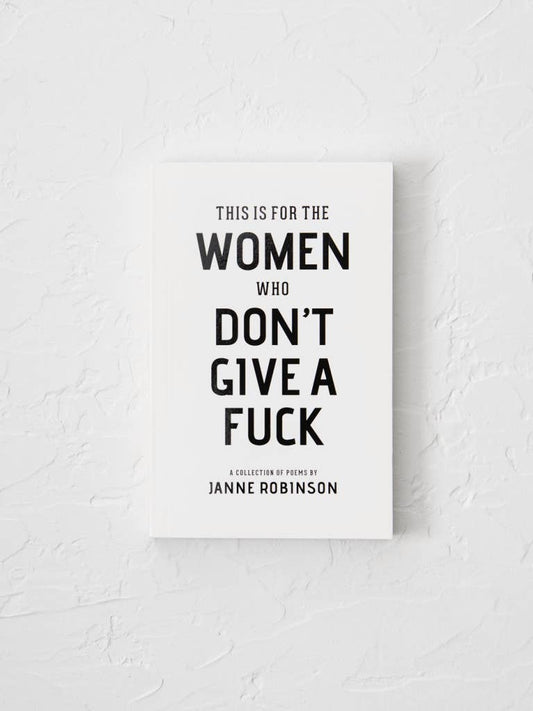Book titled 'This is for the Women Who Don't Give a Fuck' by Janne Robinson on a textured white background