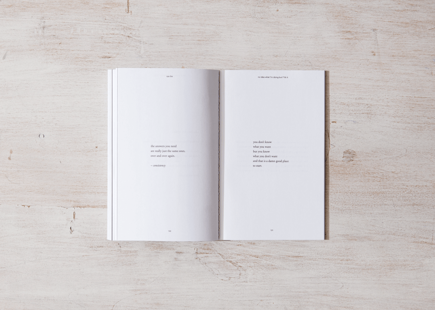 Open book with white pages on a light wooden surface