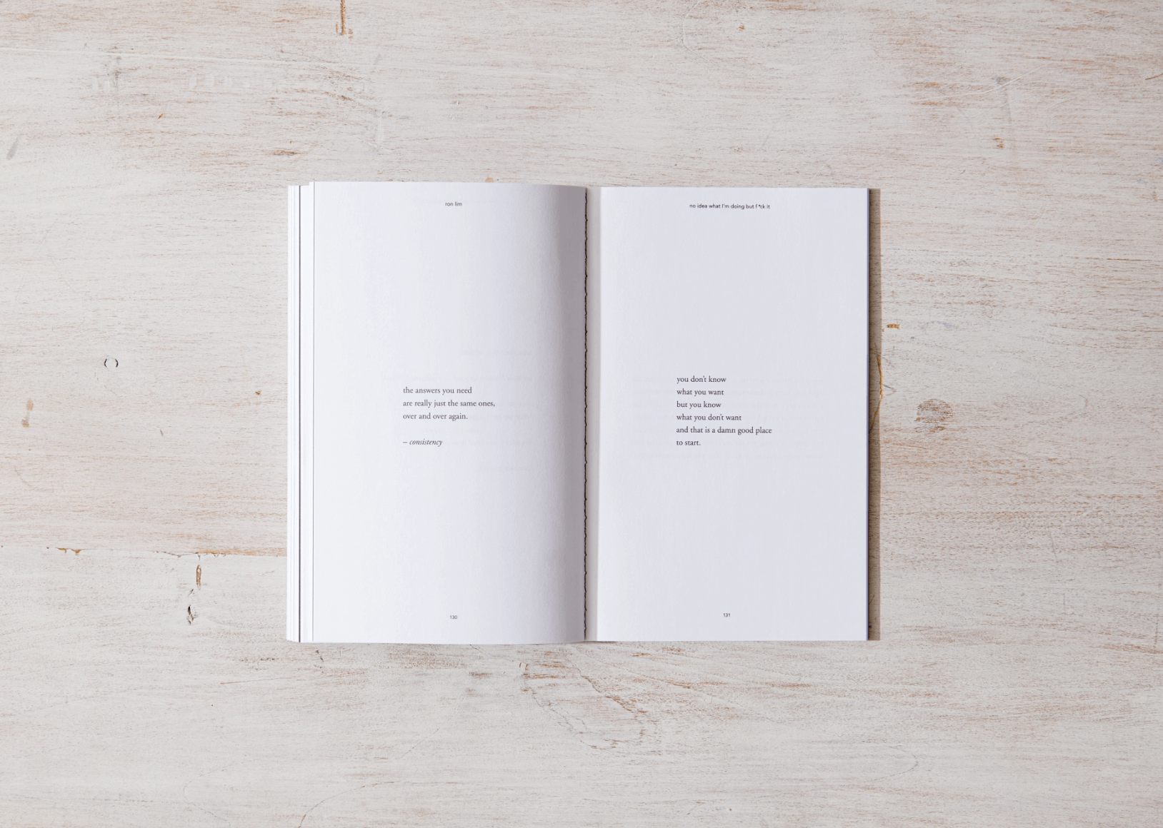 Open book with white pages on a light wooden surface