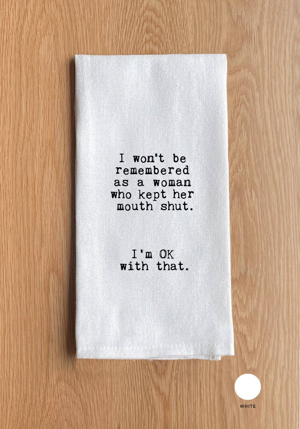 White towel with black text on a wooden surface