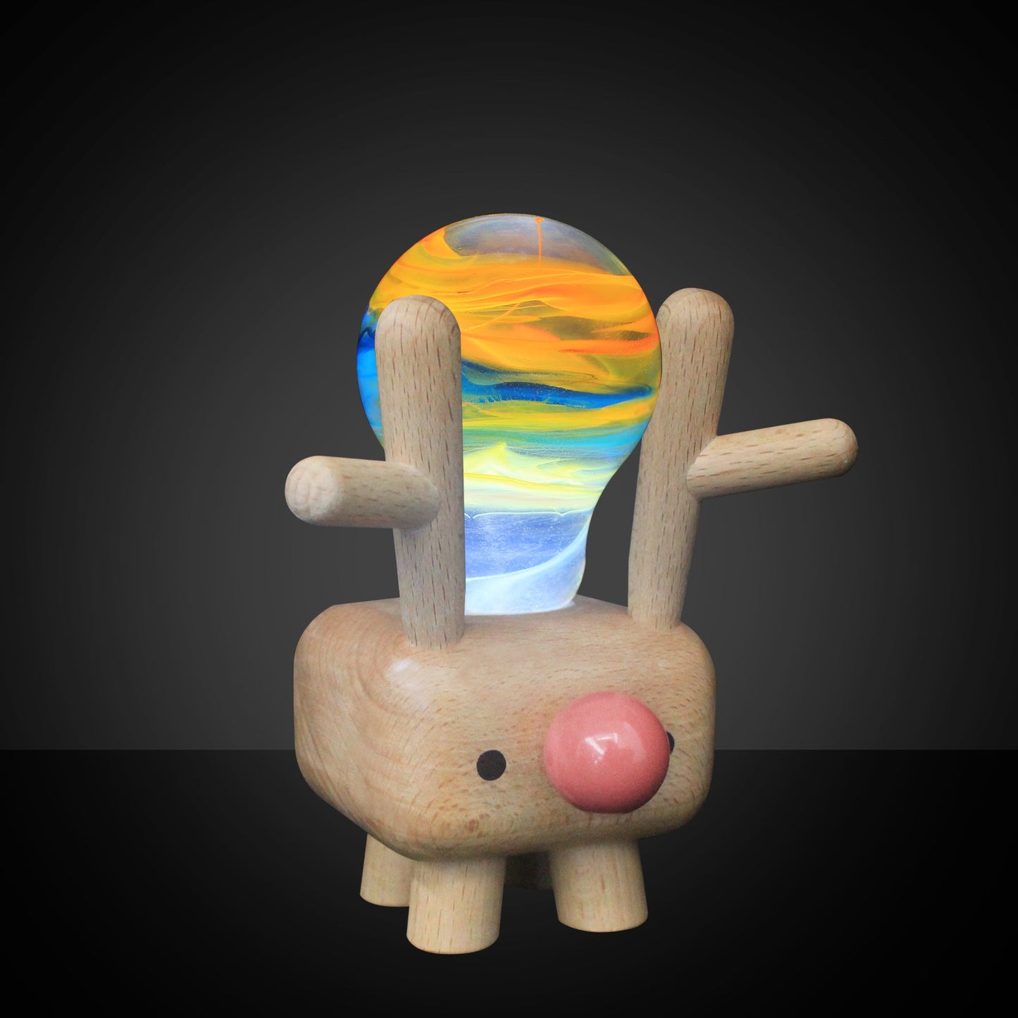 Wooden toy with a colorful glass ball on its head against a black background