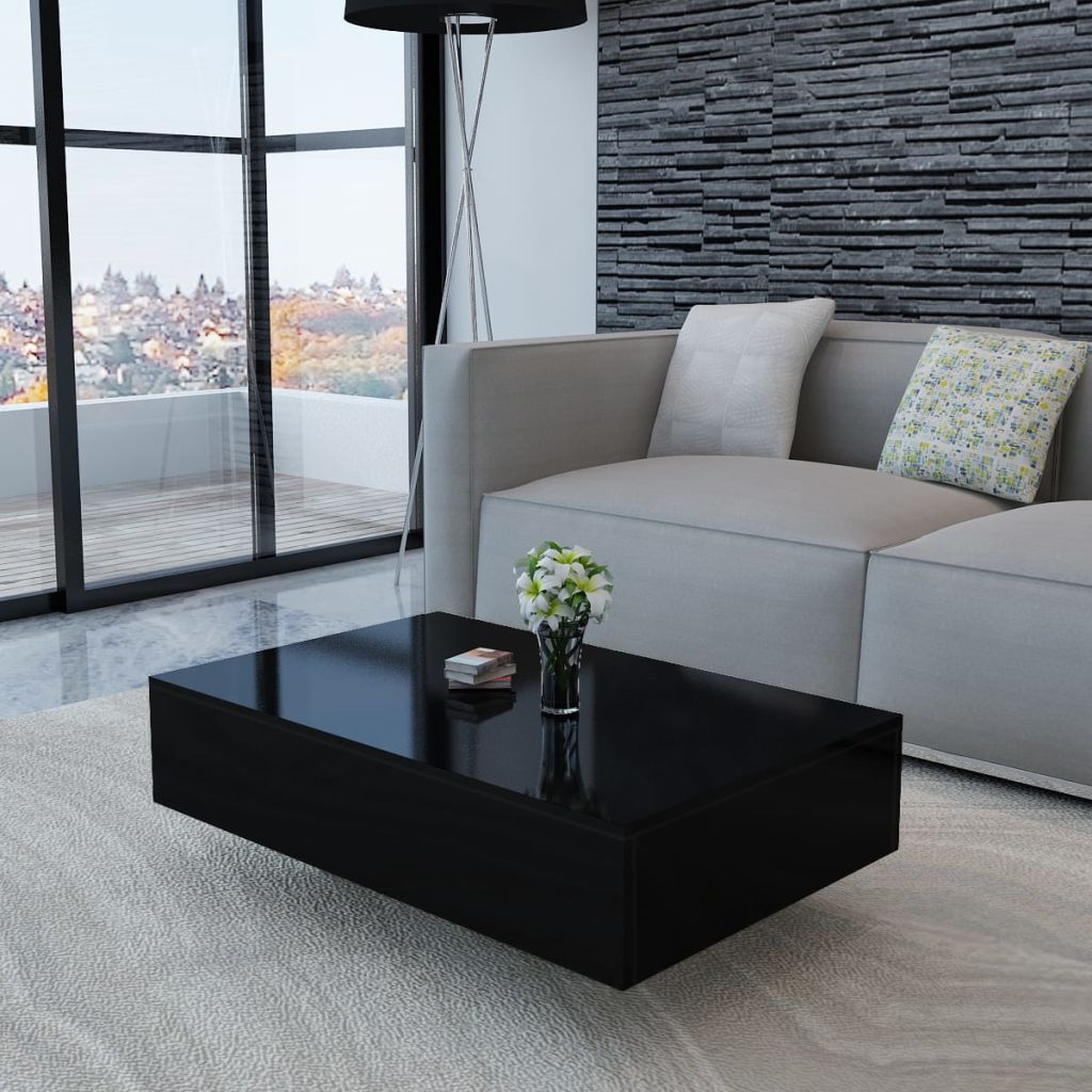 Modern living room with a black coffee table, gray sofa, and decorative pillows.