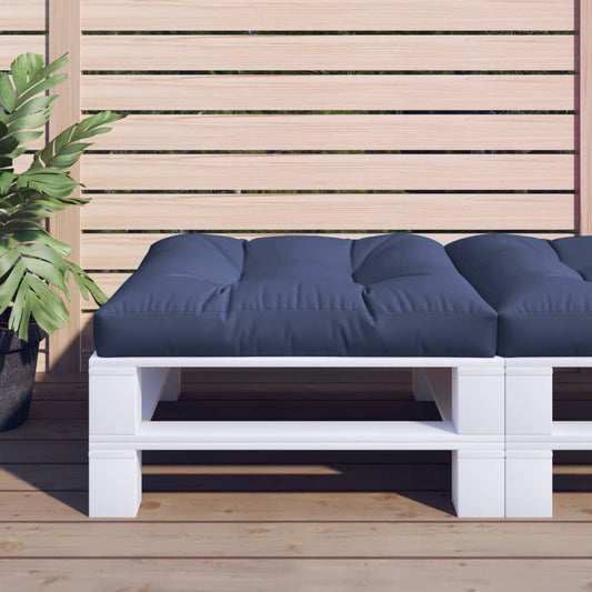 White pallet bench with navy cushions on a wooden deck