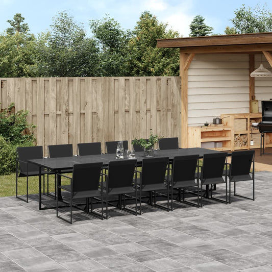 Outdoor patio set with black dining table and chairs on a stone patio.