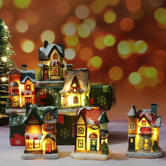 Set of illuminated miniature Christmas houses with a festive background
