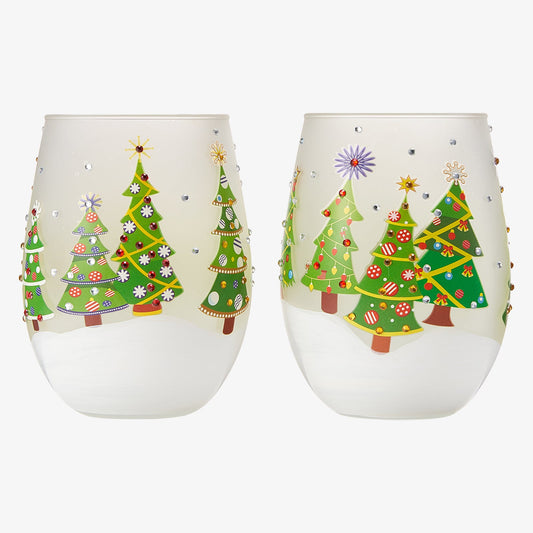 Two stemless wine glasses with Christmas tree designs on a white background