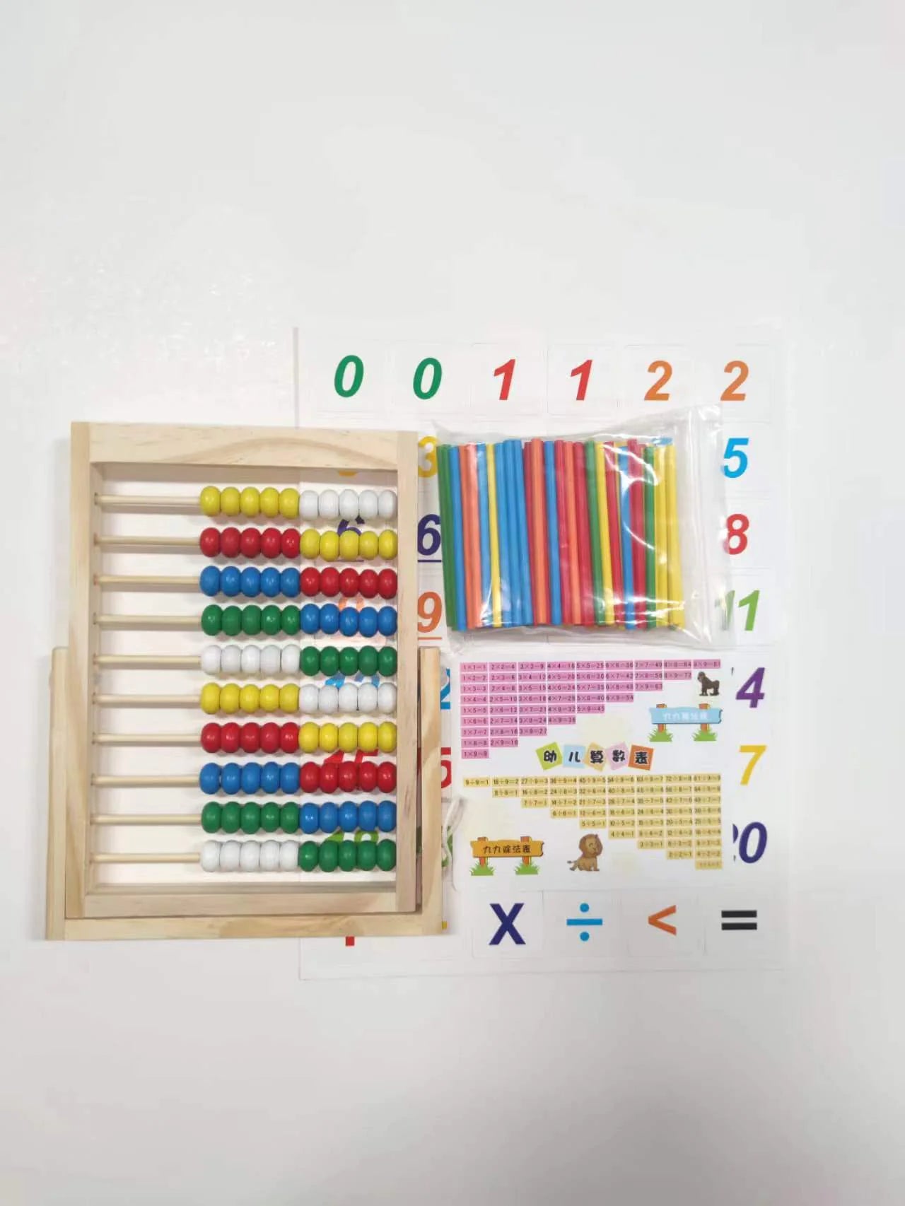 Educational tools including an abacus, counting sticks, and number cards on a white background.