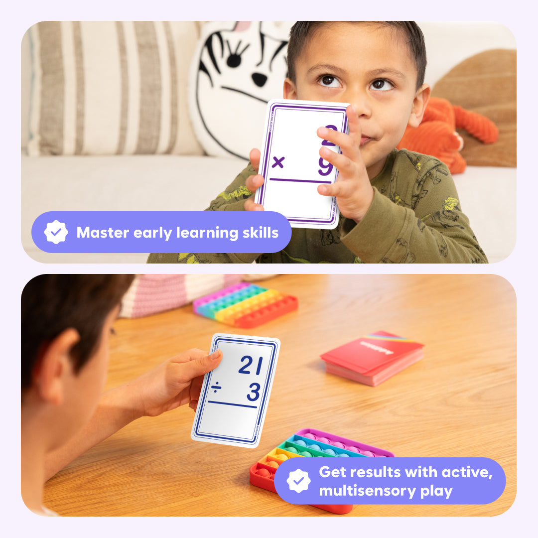 Child holding a math card with educational text, surrounded by colorful learning tools on a wooden surface.