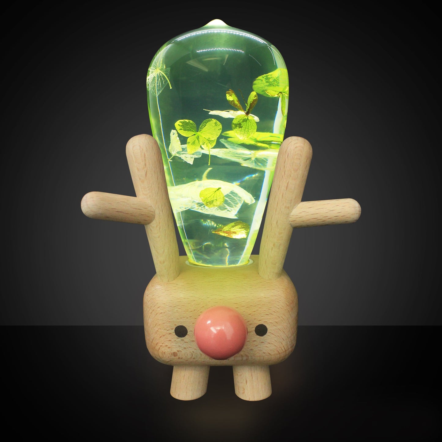 Wooden reindeer figure with a glowing green interior on a black background