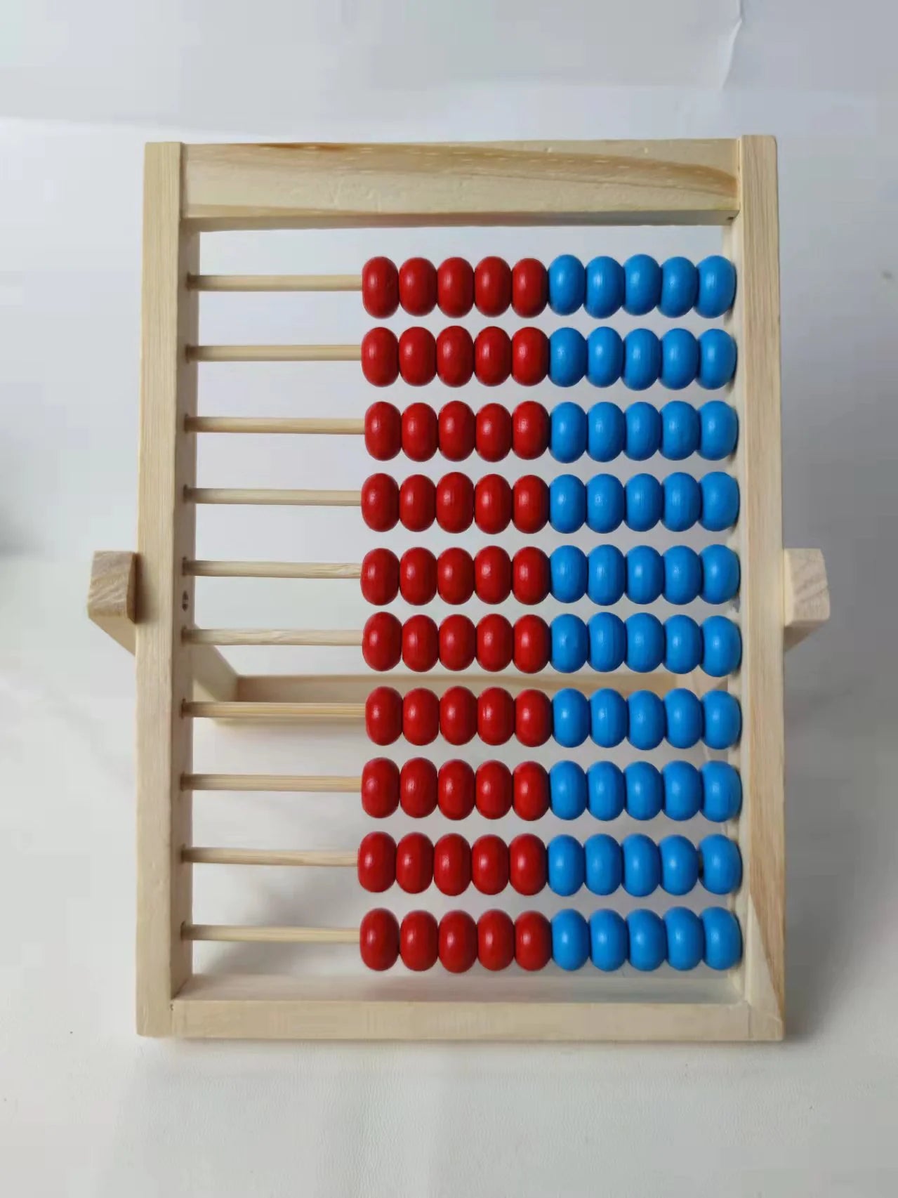 Wooden abacus with red and blue beads on a white background