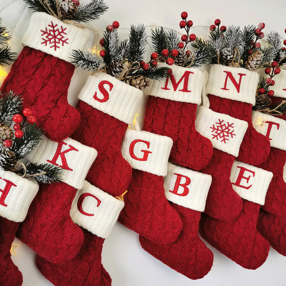 Red Christmas stockings with white letterings on a white background