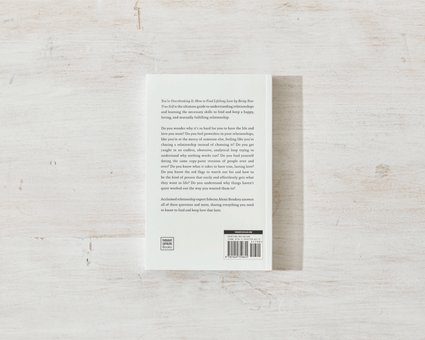 Back cover of a book on a light wooden surface