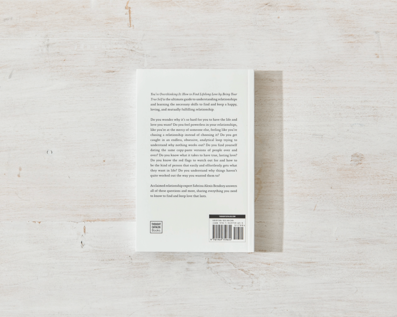 Back cover of a book on a light wooden surface