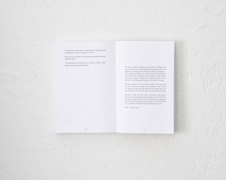 Open book with text on a white textured surface