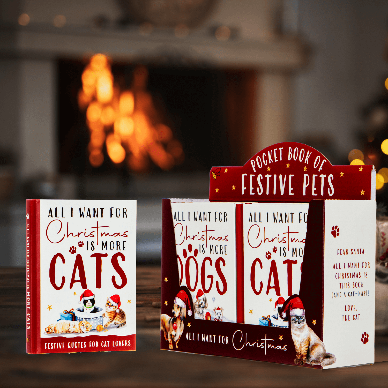 Pocket books with festive pet-themed designs on a blurred fireplace background