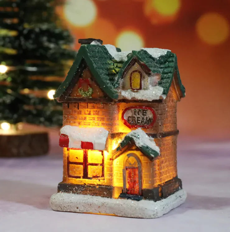 Decorative ice cream shop model with lights on a blurred Christmas tree background