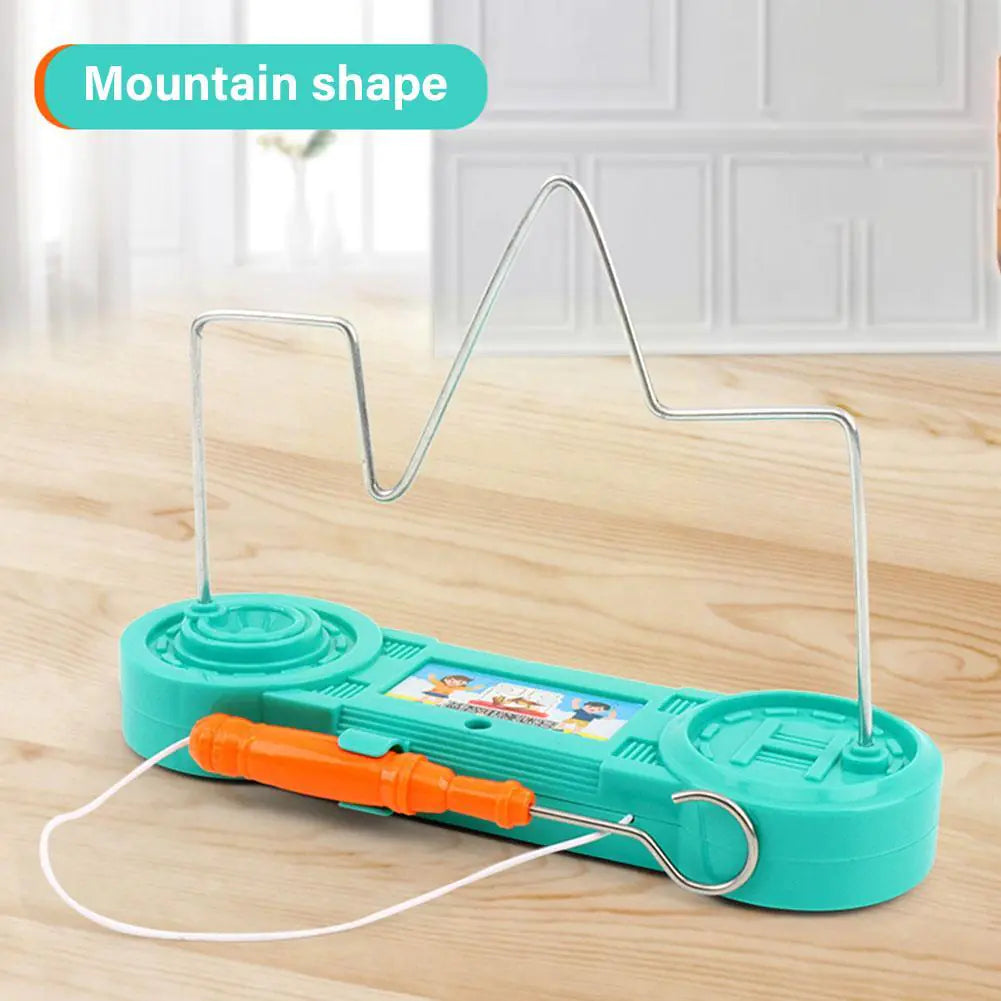 Teal kite frame with orange handle on a wooden surface