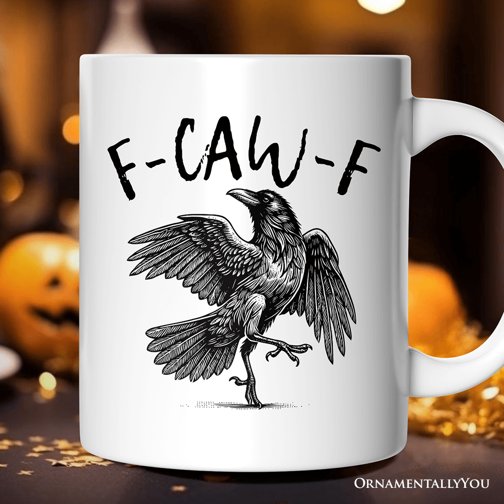 White mug with a black crow illustration and 'F-CAW-F' text on a blurred Halloween-themed background.