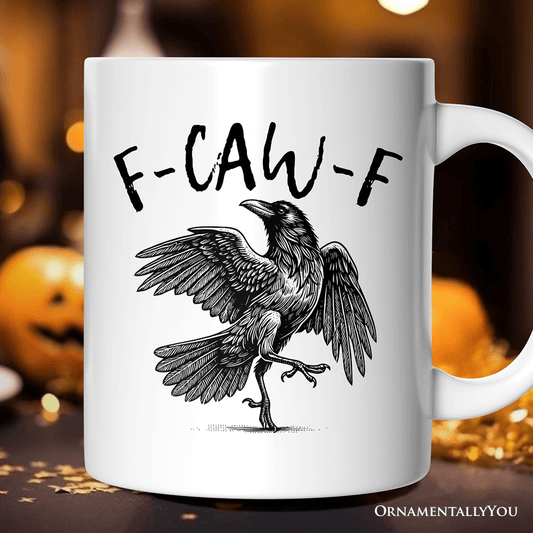 White mug with a black crow illustration and 'F-CAW-F' text on a blurred Halloween-themed background.