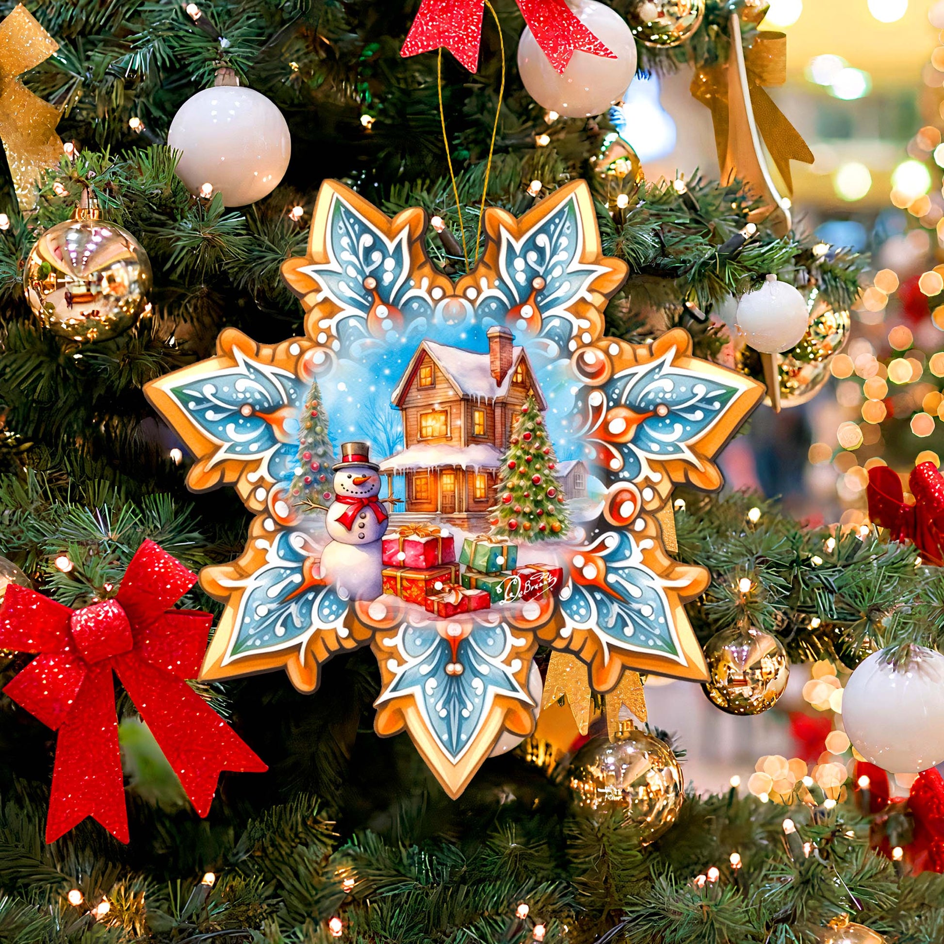 Decorative Christmas ornament on a tree with a snowy village scene