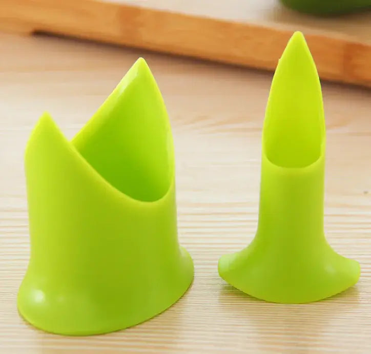 Two green silicone cup holders on a wooden surface