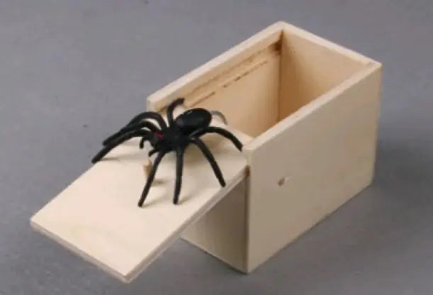 Wooden box with a false spider on a gray background