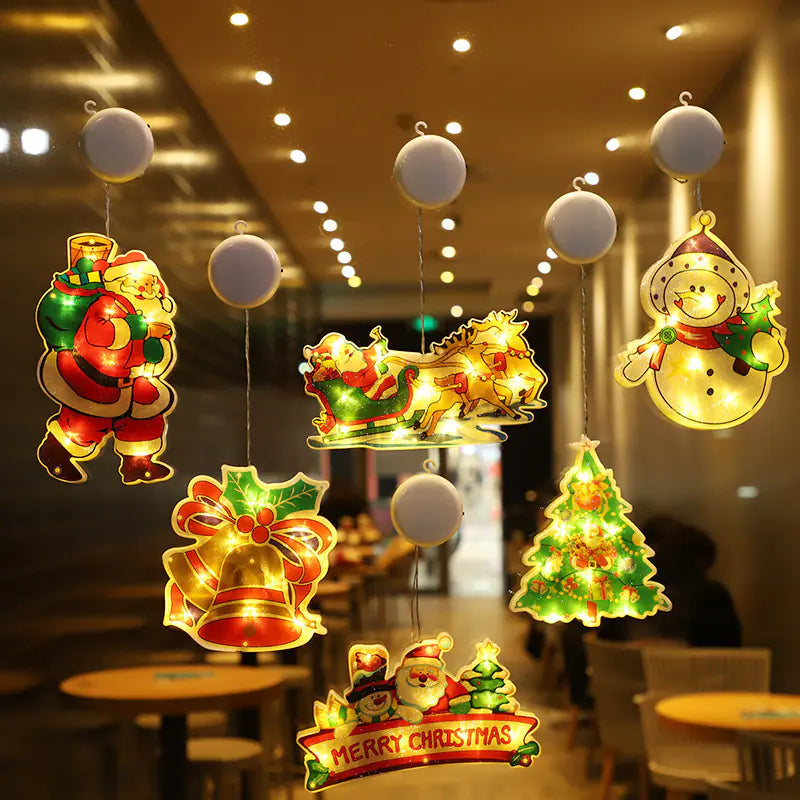 Decorative Christmas lights shaped like Santa Claus, reindeer, and Christmas tree hanging in a restaurant.